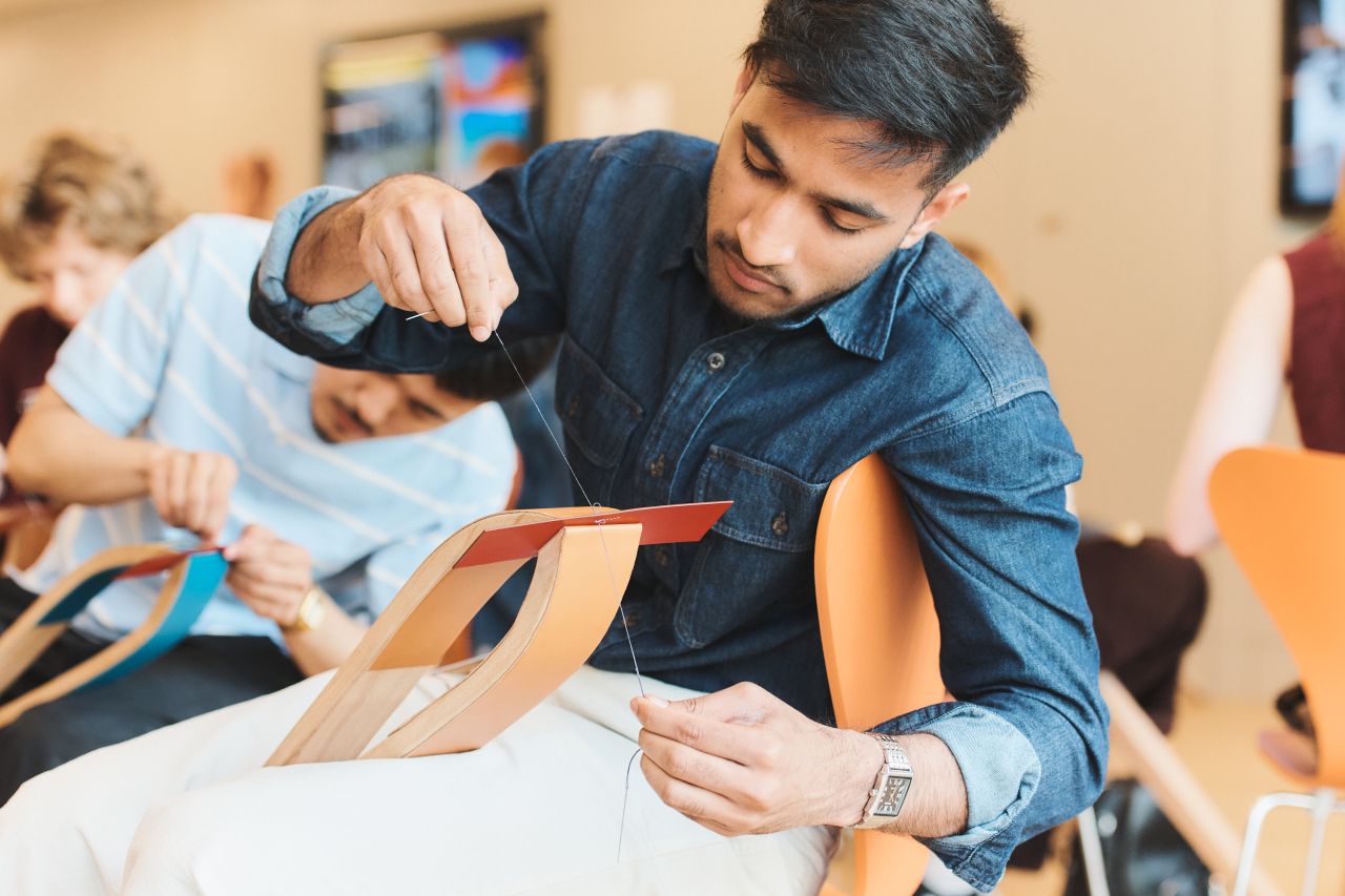 Student practising saddle stitching during an Hermès workshop