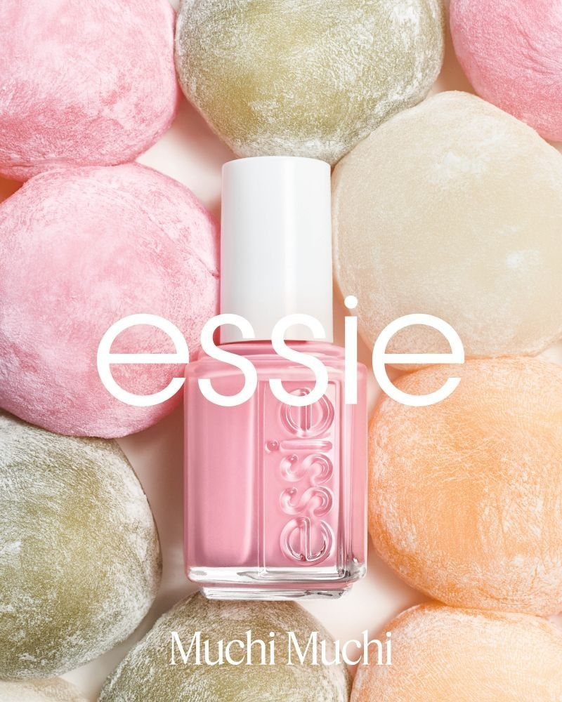 essie Muchi Muchi pink nail polish bottle surrounded by pastel-colored sweets