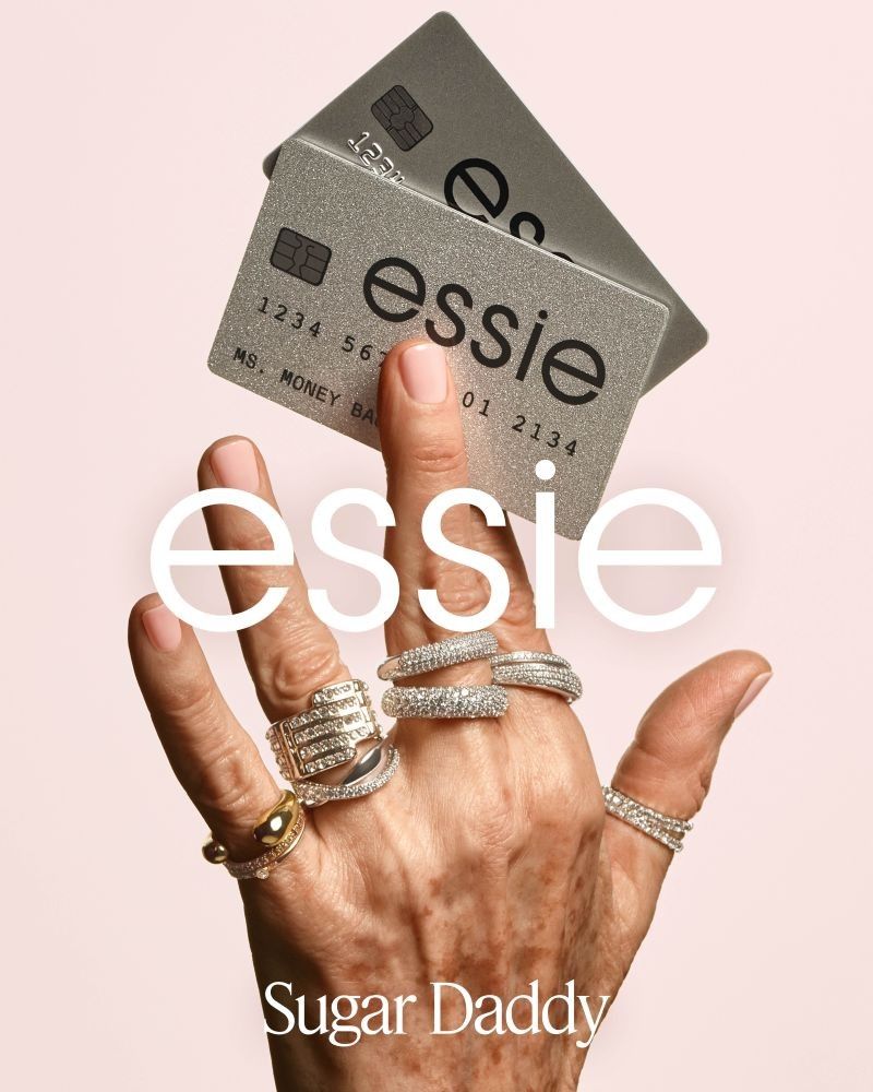 essie Sugar Daddy campaign visual with a ring-adorned hand holding branded card props