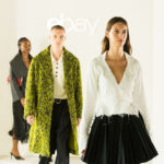 Three models walk beneath the eBay logo at its 2026 London Fashion Week Endless Runway show