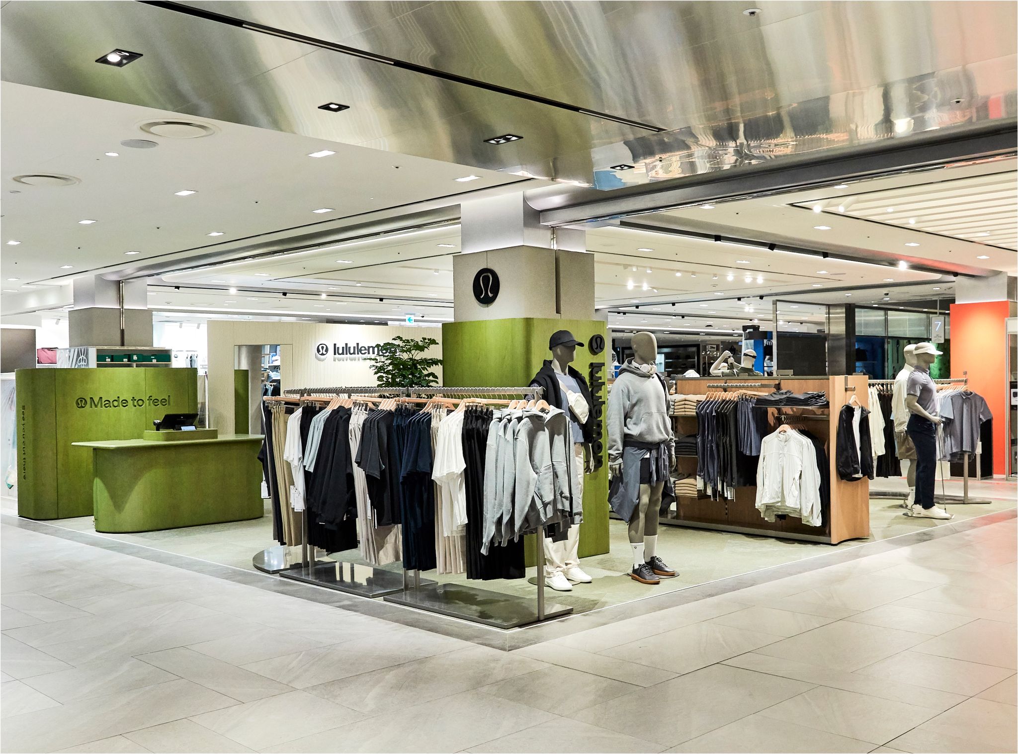 Men’s apparel racks and styled mannequins inside lululemon’s Shinsegae Gangnam pop-up