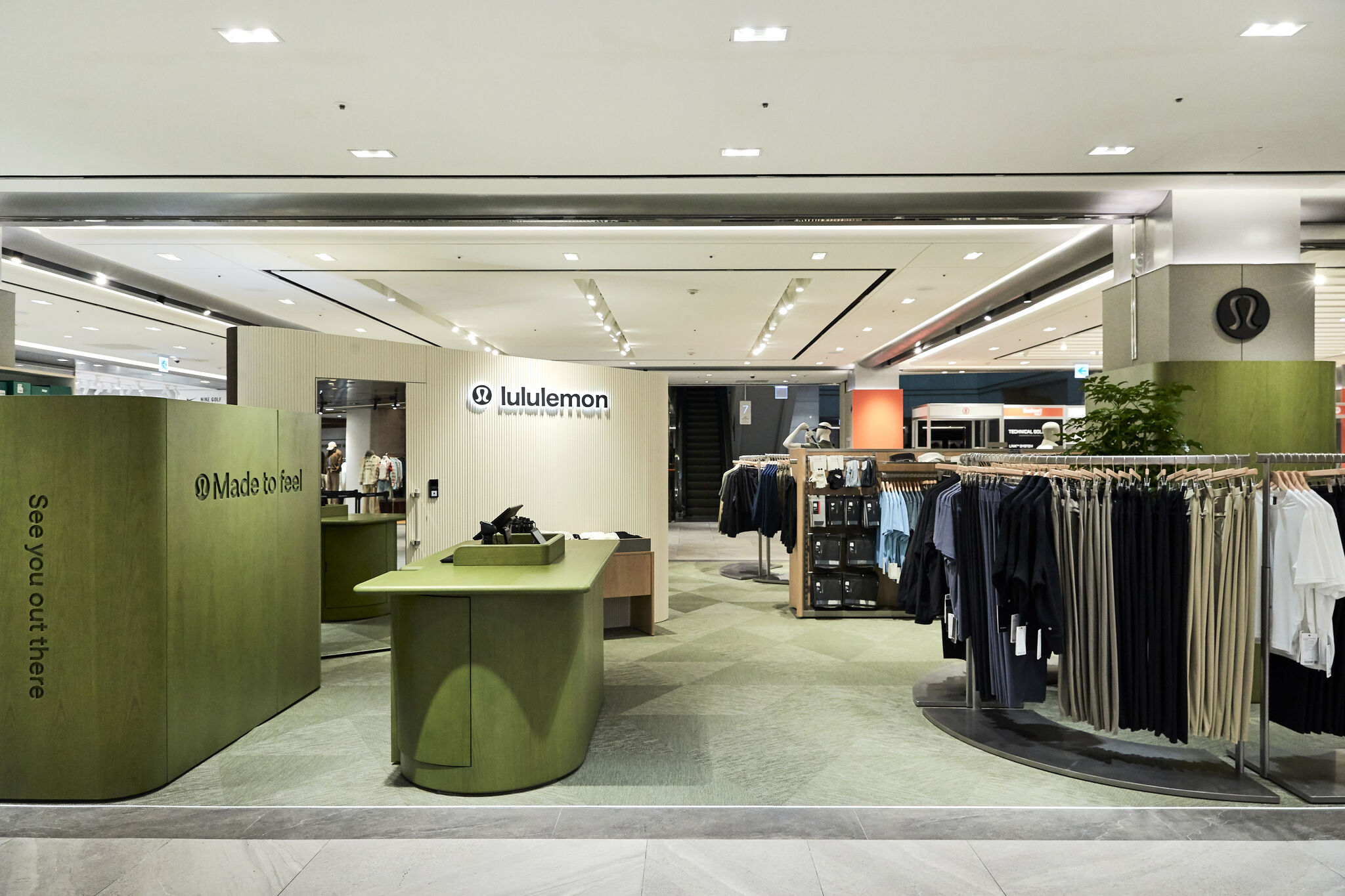 Green counter and men’s clothing displays at lululemon Shinsegae Gangnam