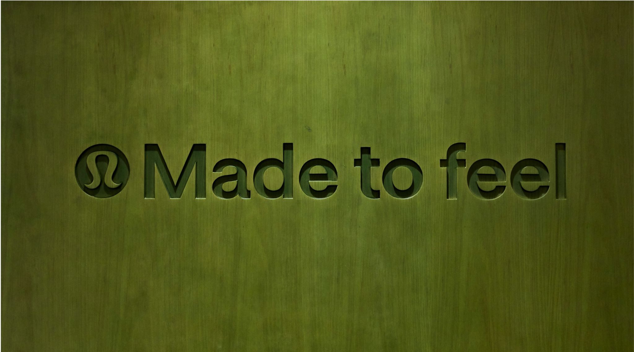 lululemon Made to feel lettering on a green wall