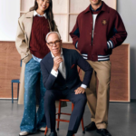 Tommy Hilfiger seated between two models wearing his Macy’s collection.