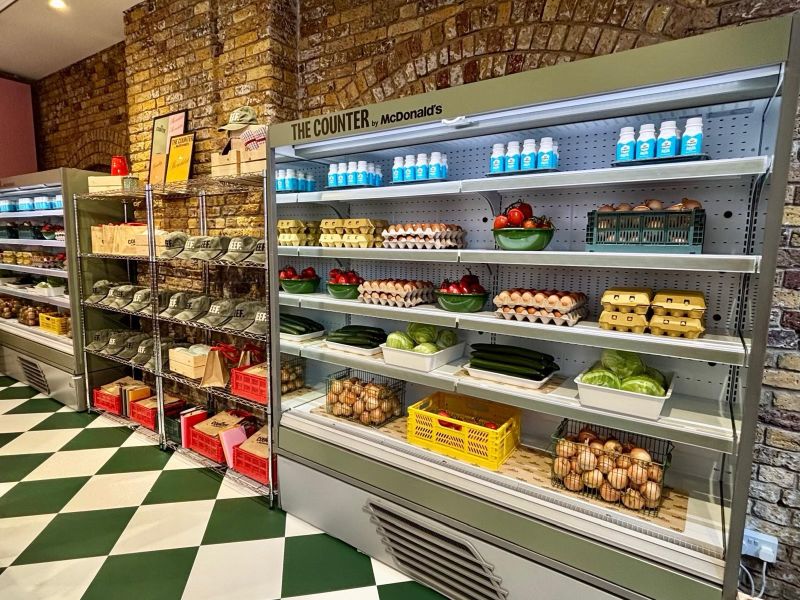 Shelving and green-and-white flooring inside The Counter