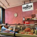 Butcher-style counter and McDonald’s signage at the pop-up