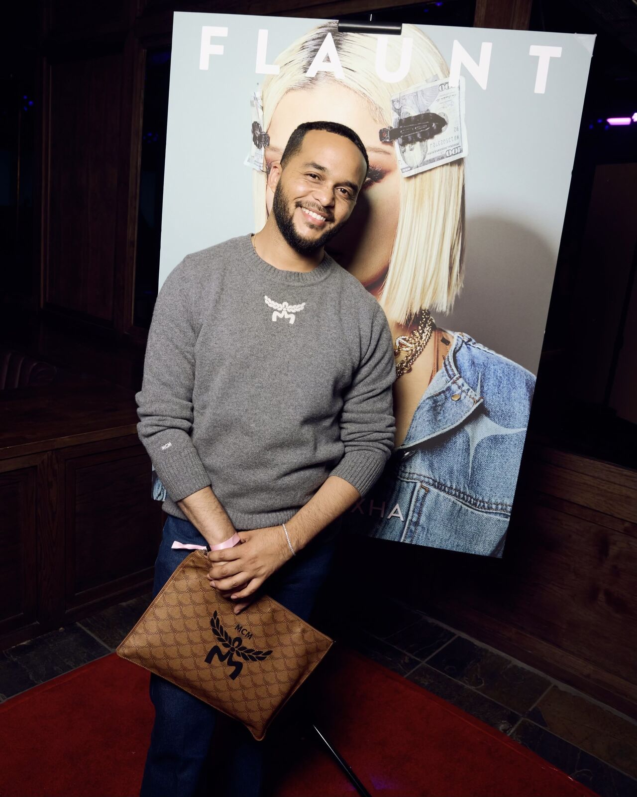 Guest with MCM bag beside the Flaunt cover display