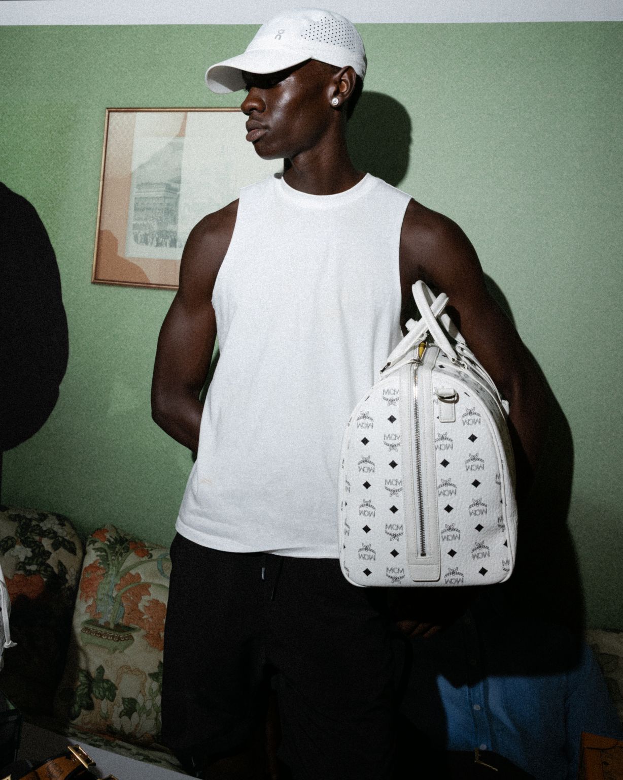 Participant holding a white MCM monogram bag