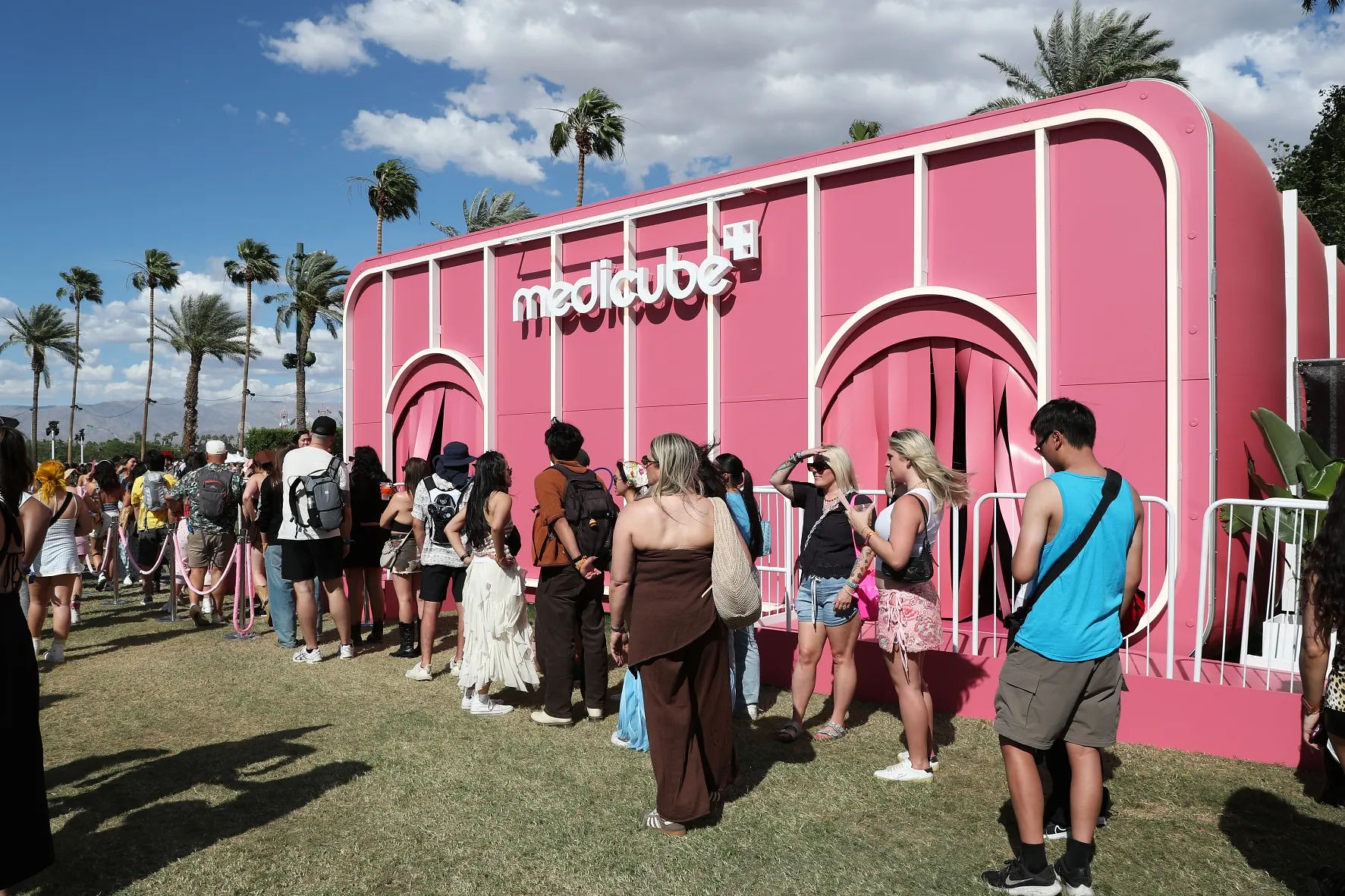 Visitors queued outside a pink Medicube activation at Coachella.