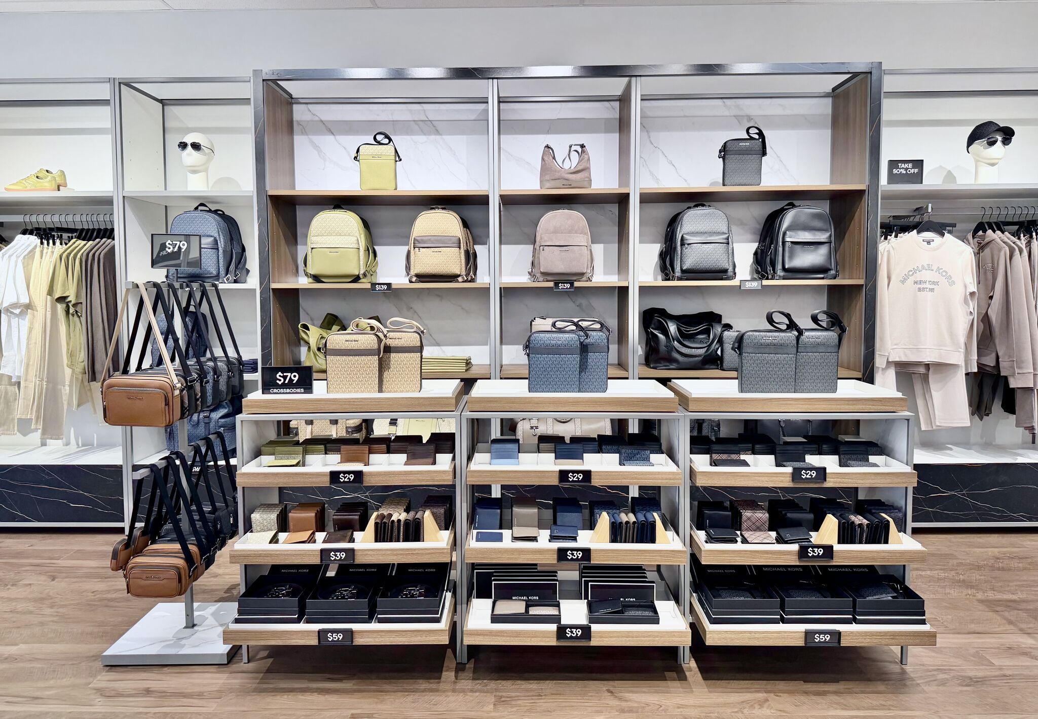 Bags and clothing display at Michael Kors Mens