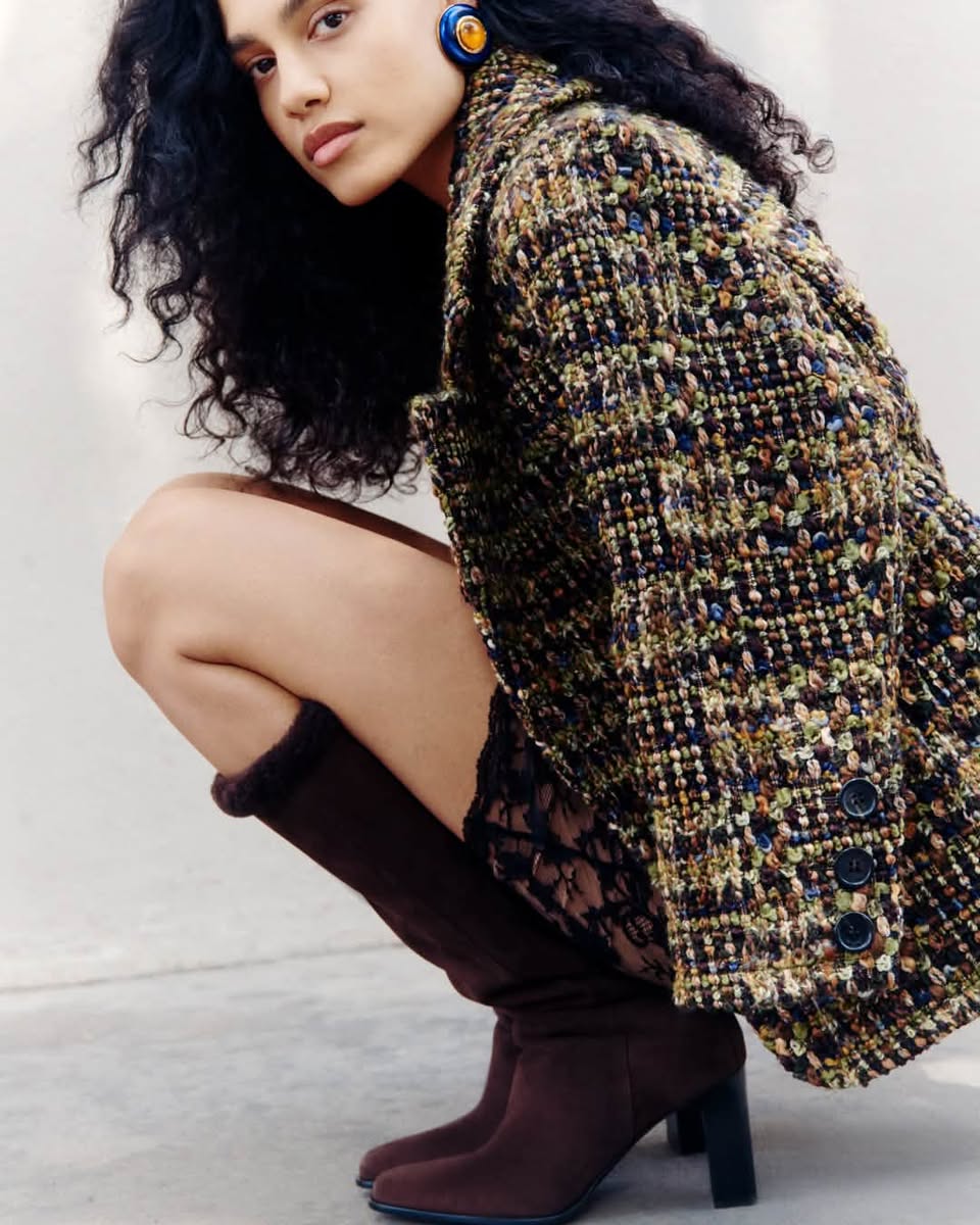 Model wearing dark boots with textured jacket in the exclusive Jimmy Choo edit