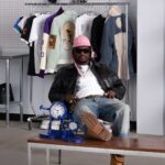 Creative seated in an Off-White 10x10 studio setting with garments on a rack