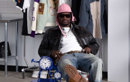 Creative seated in an Off-White 10x10 studio setting with garments on a rack