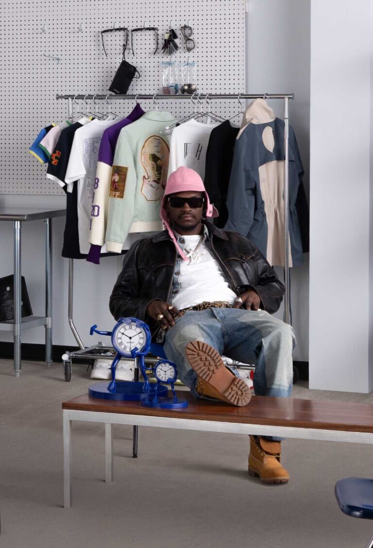 Creative seated in an Off-White 10x10 studio setting with garments on a rack