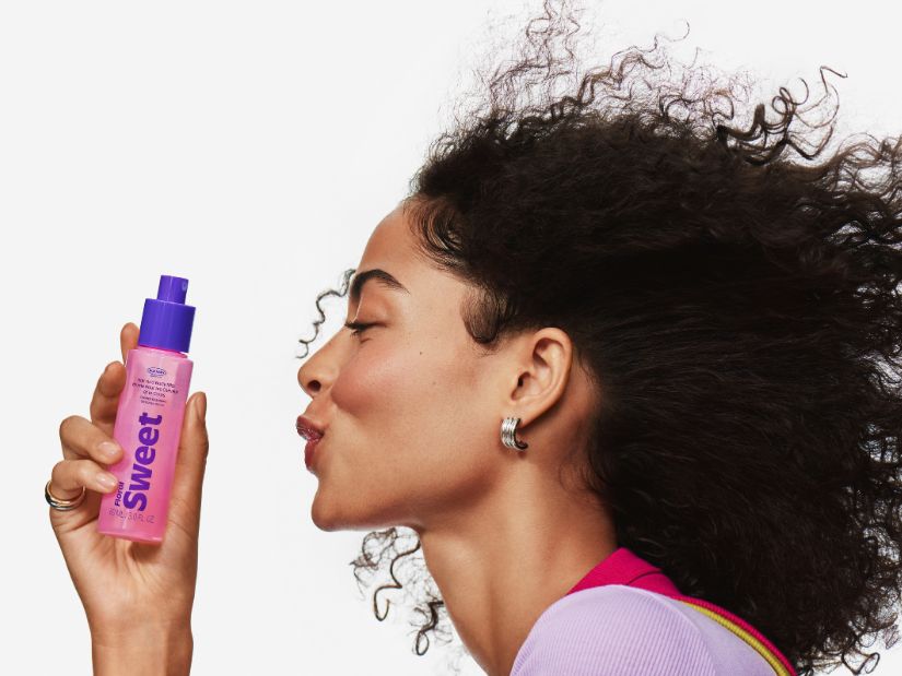 Model holding an Old Navy Beauty Co. Floral Sweet mist bottle