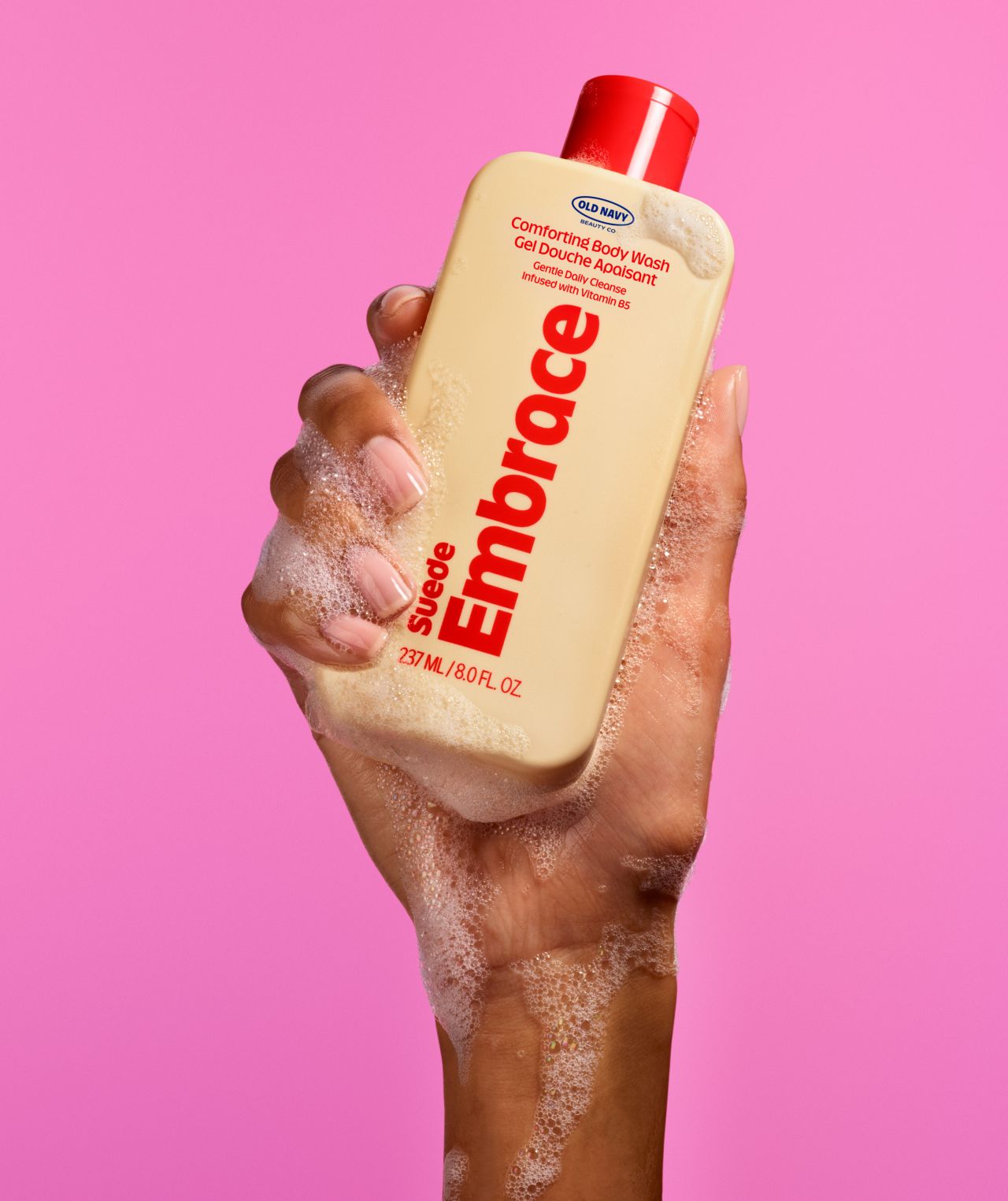 Old Navy Beauty Co. Suede Embrace body wash held against a pink background