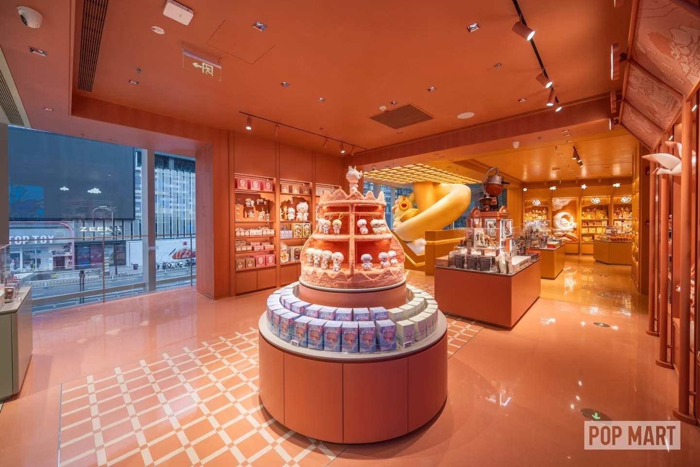 Circular merchandise table in the orange POP MART display zone