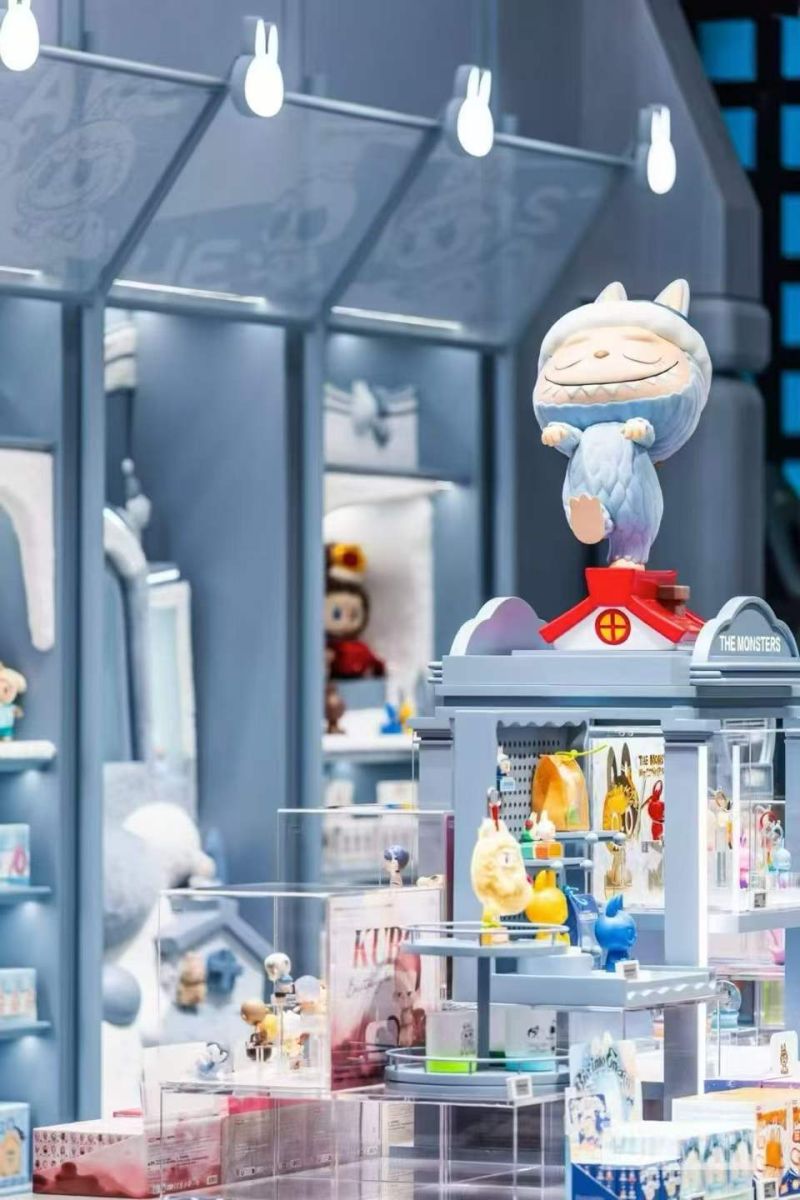 Blue character-themed display with figures and boxed products