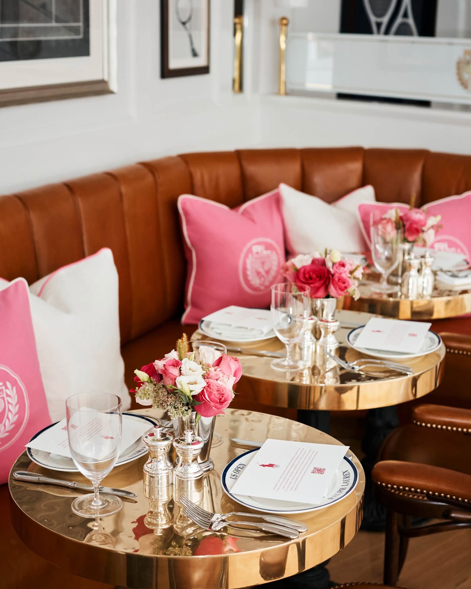 Pink cushions and floral table arrangements in Ralph Lauren's US Open suite.