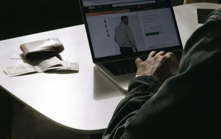 Shopper comparing a fashion product page with star ratings on a laptop