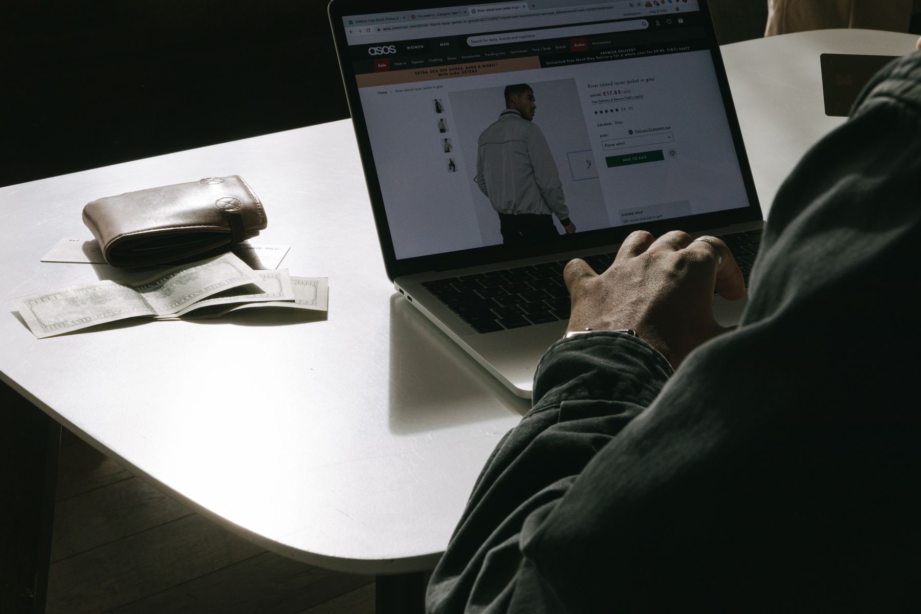 Shopper comparing a fashion product page with star ratings on a laptop