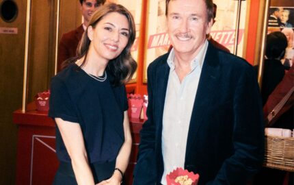 Guests at the Cartier Cinema Club event beside a Cartier popcorn stand