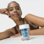 Model with a Rodan + Fields skincare product.