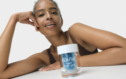 Model with a Rodan + Fields skincare product.