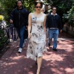 Rosalía wearing Desigual’s newspaper-print midi dress in Mexico City