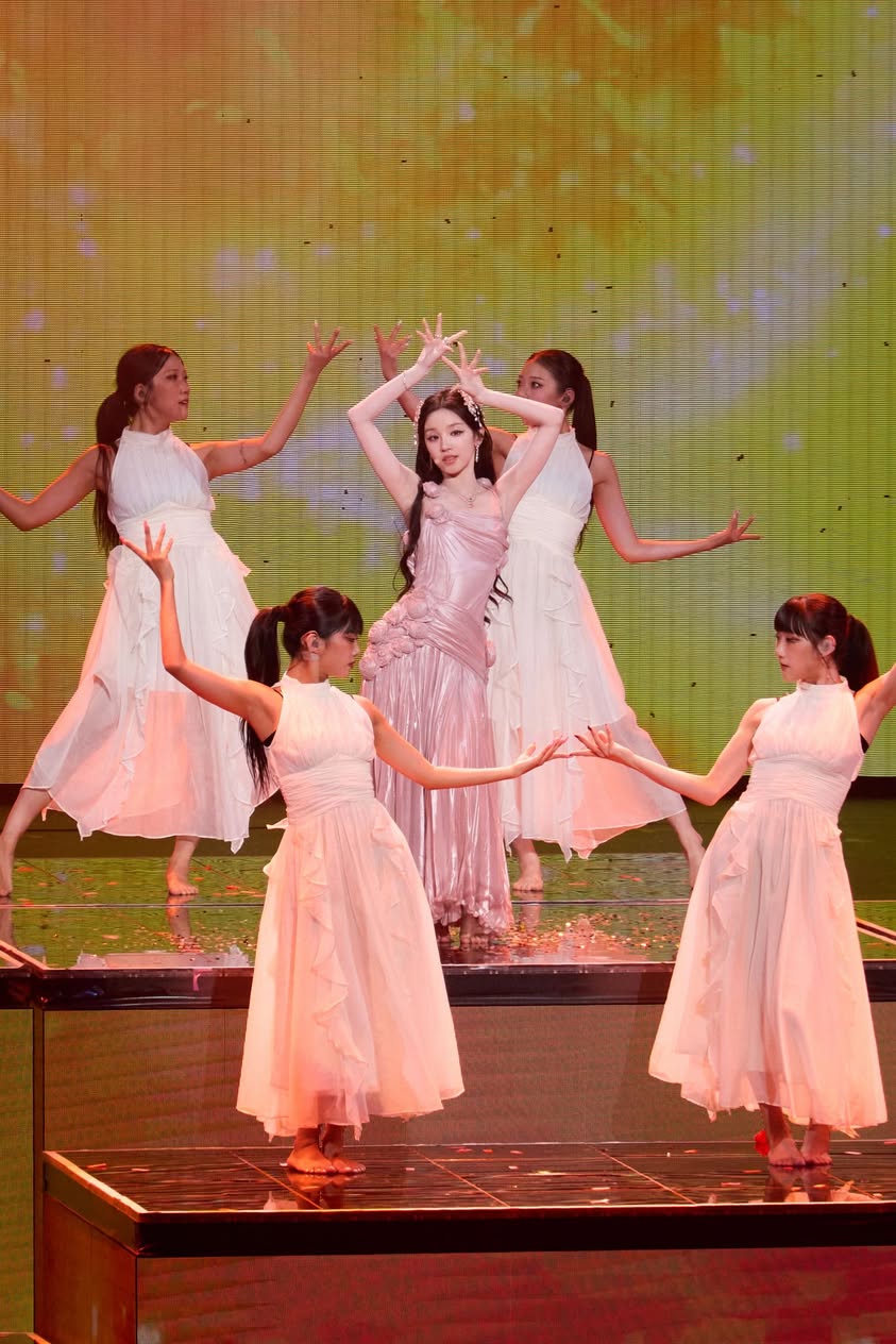 Song Yuqi onstage wearing the custom rosette gown by Tory Burch