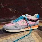 Valentino Garavani Stud Up sneakers with pink panels, turquoise laces, butterfly embroidery and studded detailing.