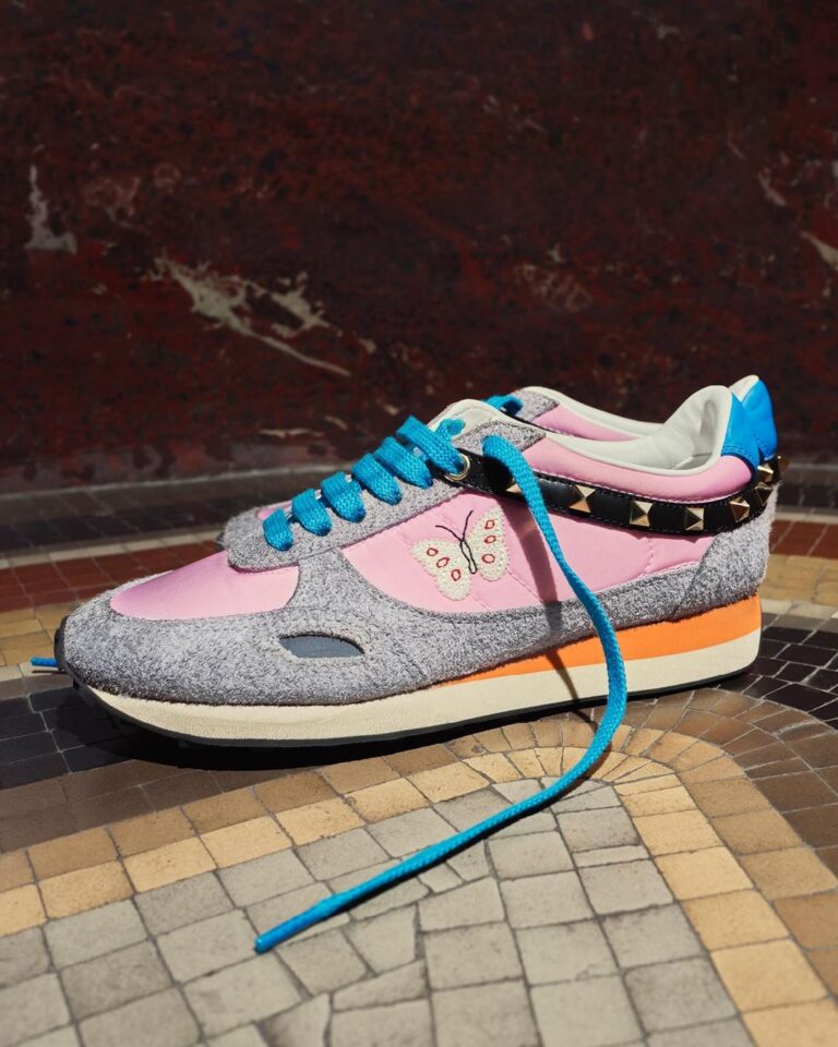 Valentino Garavani Stud Up sneakers with pink panels, turquoise laces, butterfly embroidery and studded detailing.