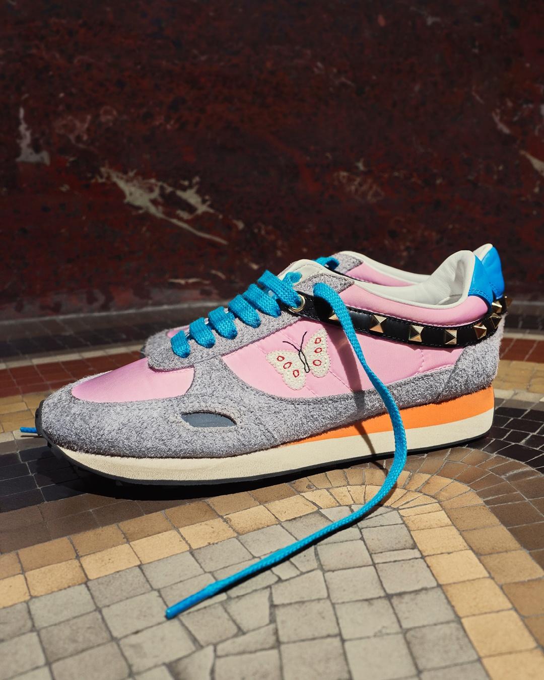 Valentino Garavani Stud Up sneakers with pink panels, turquoise laces, butterfly embroidery and studded detailing.