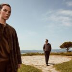 Two models in Vince fall clothing on a terrace in Italy.