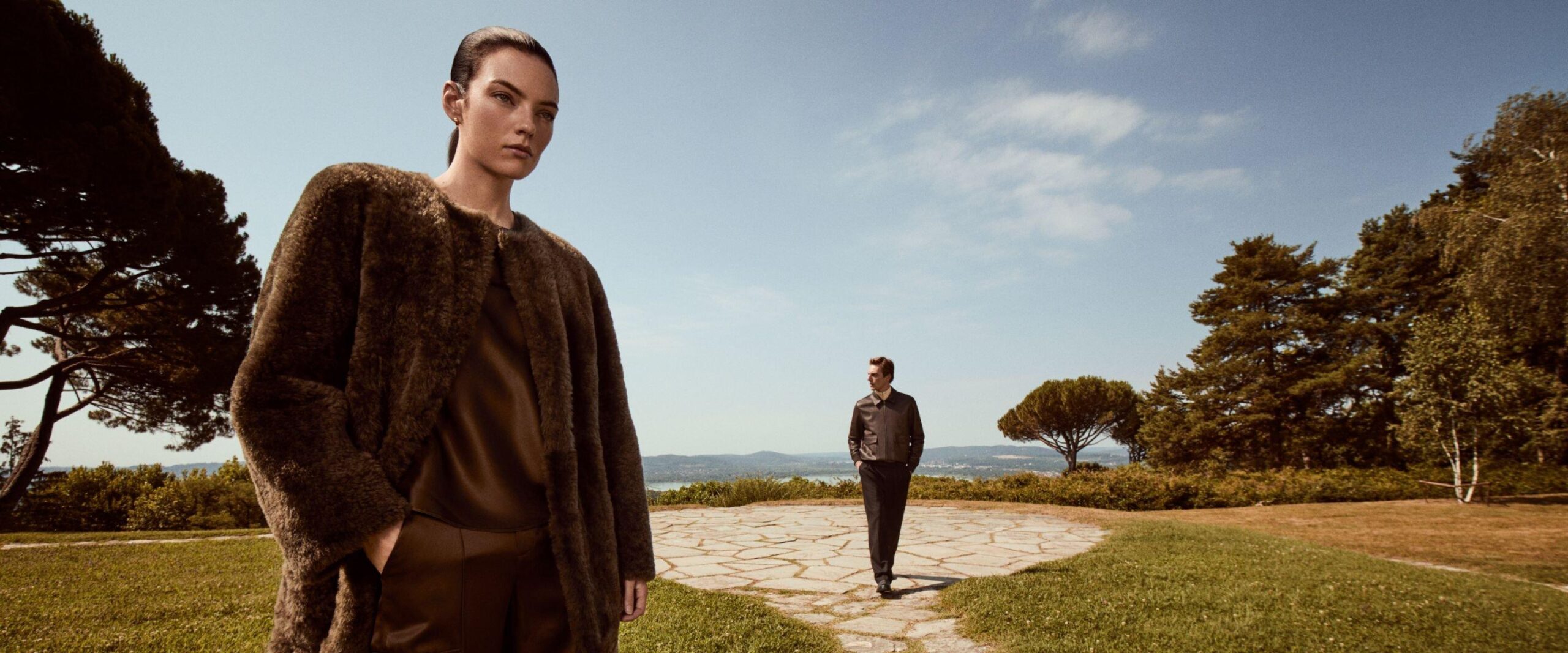 Two models in Vince fall clothing on a terrace in Italy.