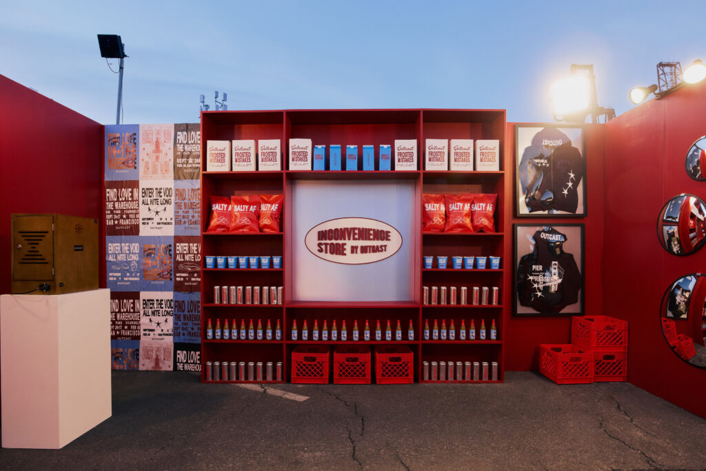 Wider shot of the back wall at dusk at Outcast Clothing’s Portola Festival pop-up