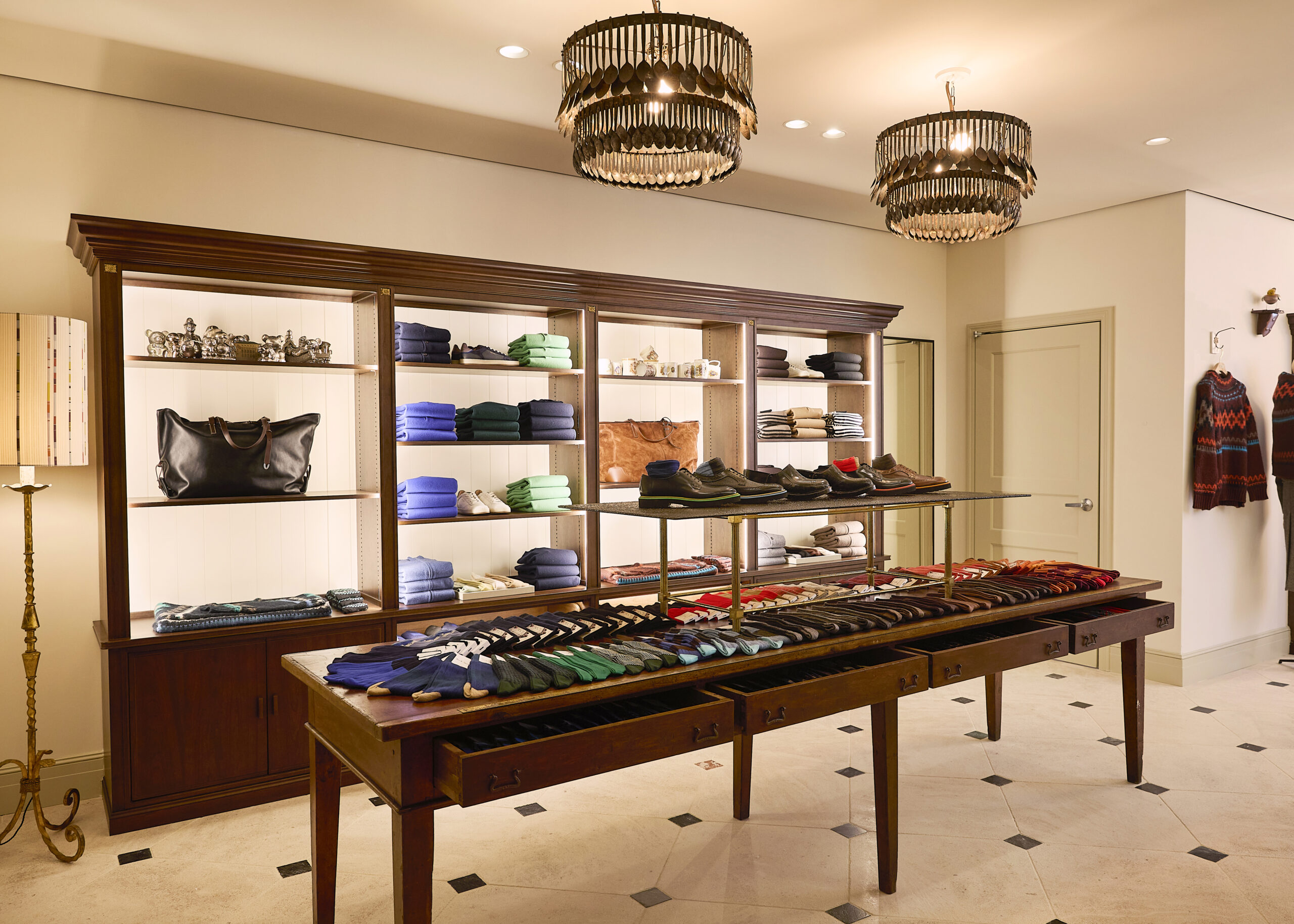 Socks and accessories displayed on a long wooden table in the Paul Smith flagship