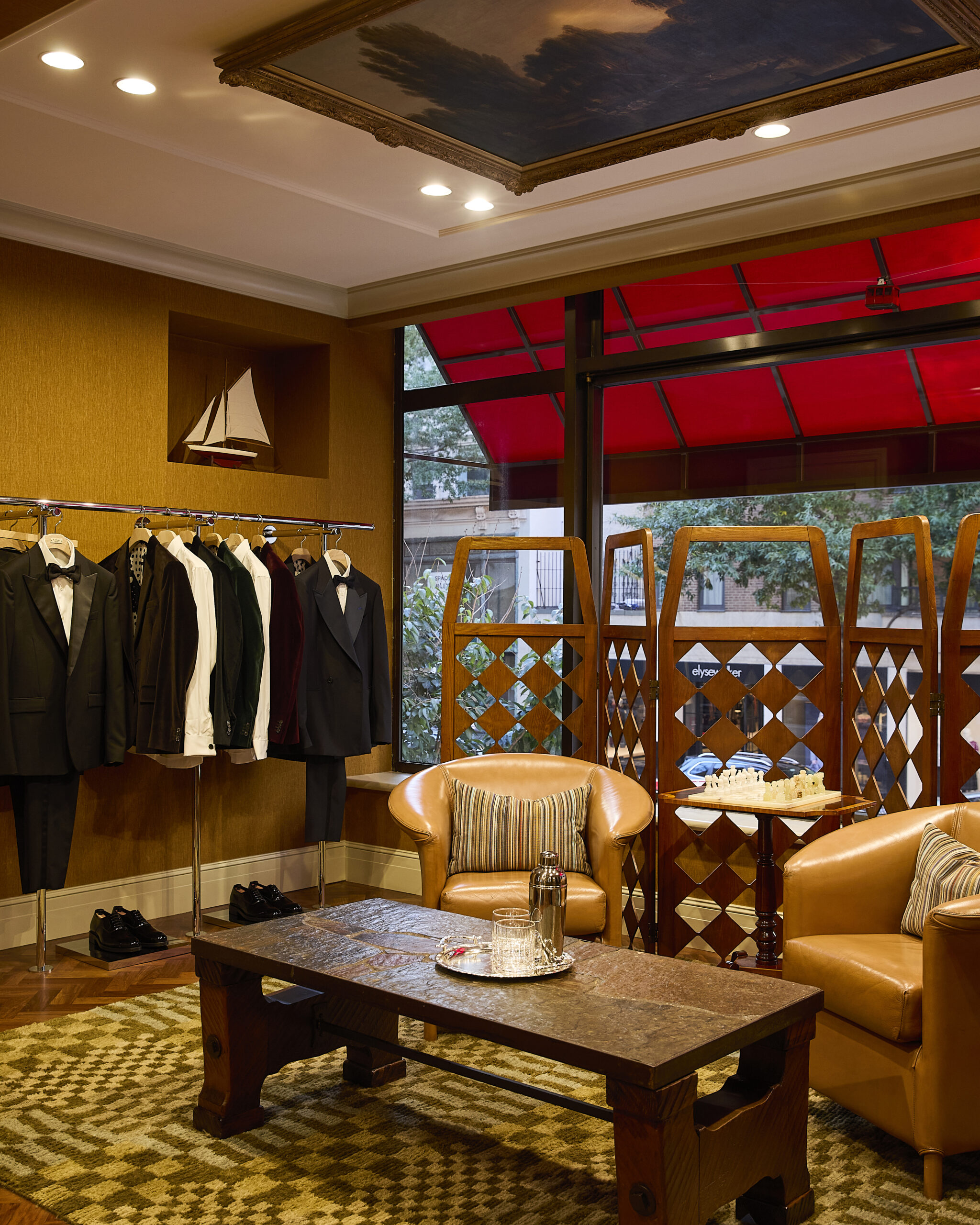 Upstairs tailoring lounge with leather chairs and occasion wear at Paul Smith Madison Avenue