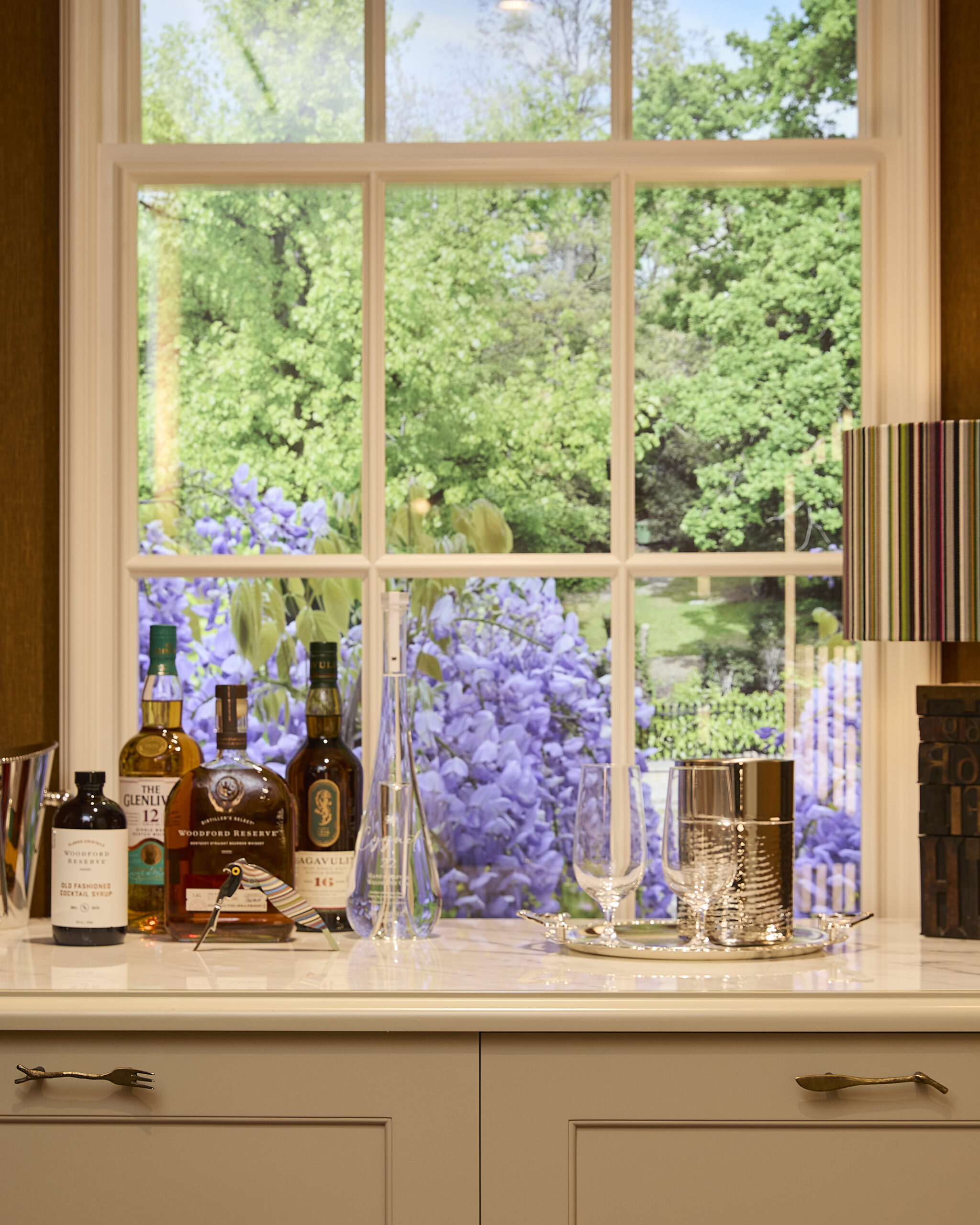 Drinks cabinet beneath a garden-image window at Paul Smith Madison Avenue