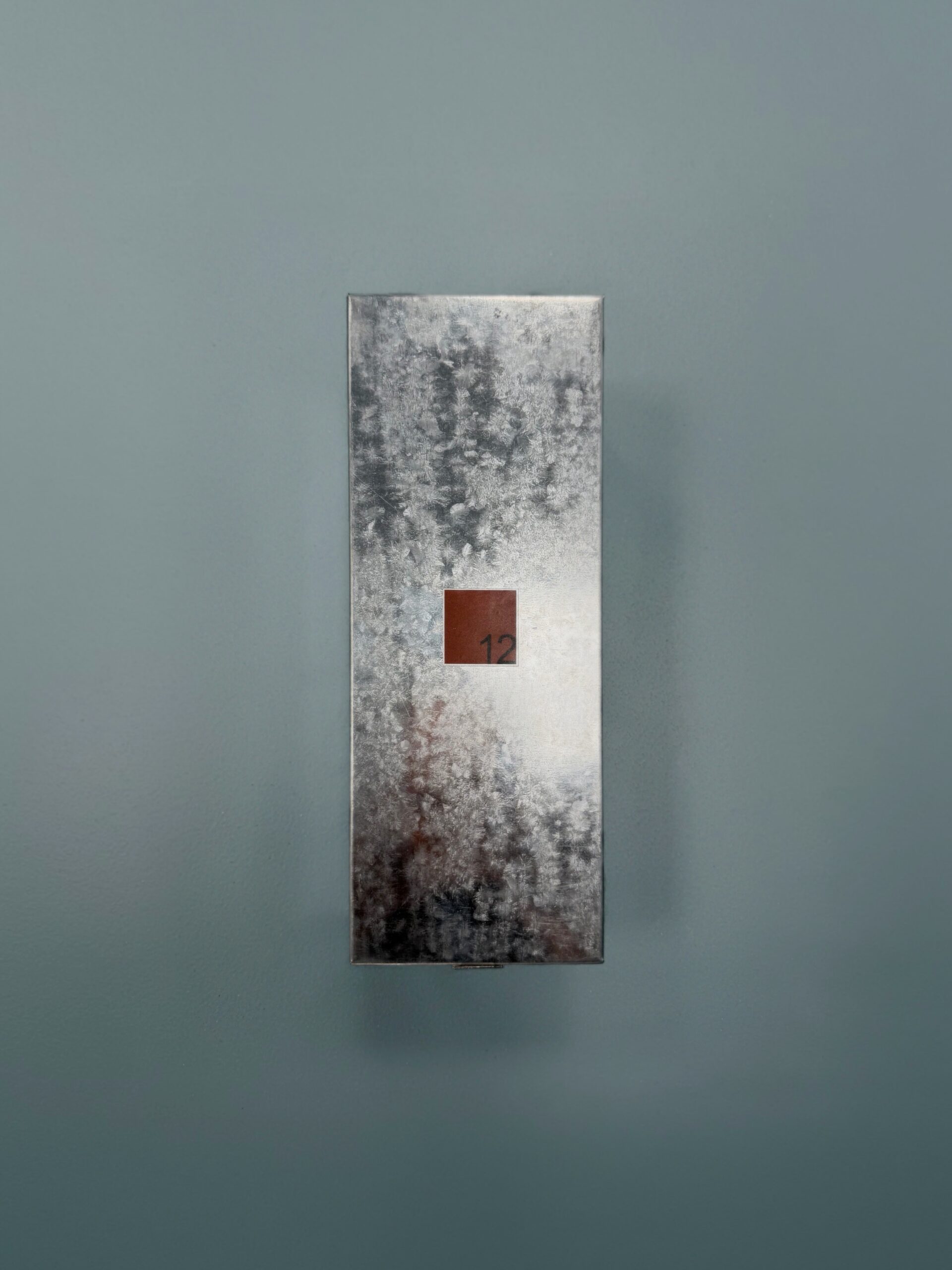 Metal panel with a square opening inside the 12_things perfume store