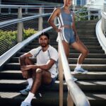 Two runners wearing adidas Chicago Marathon apparel on outdoor steps