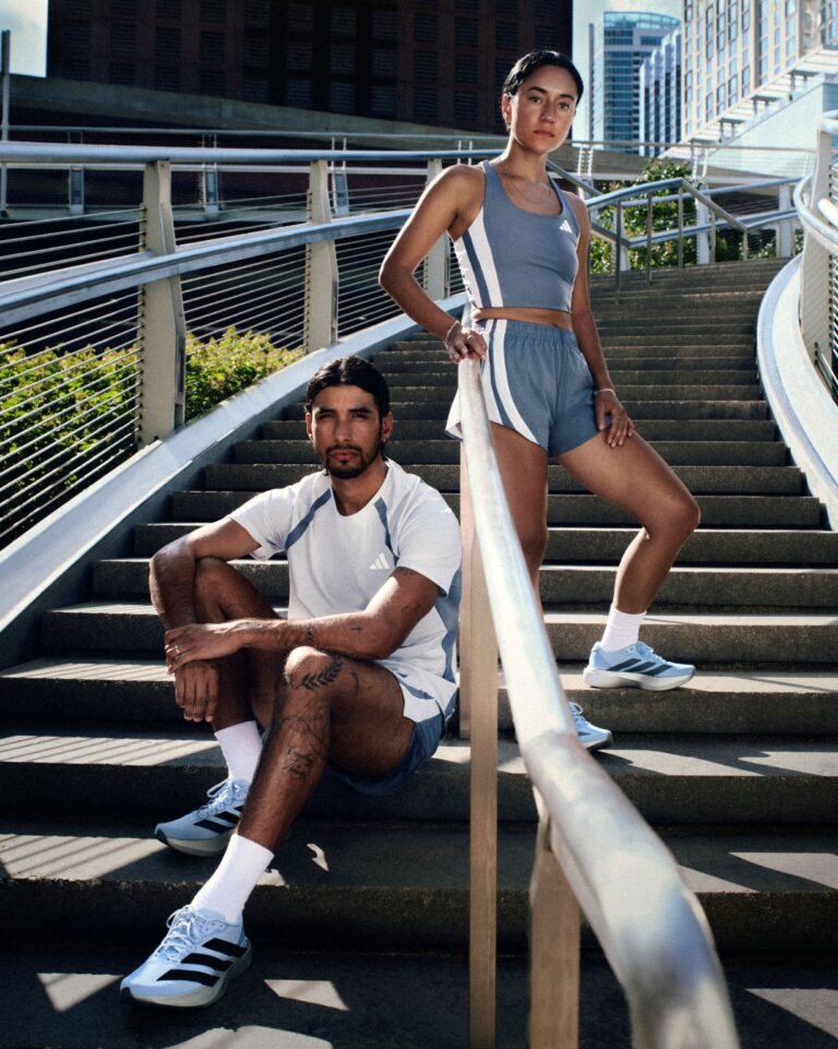 Two runners wearing adidas Chicago Marathon apparel on outdoor steps
