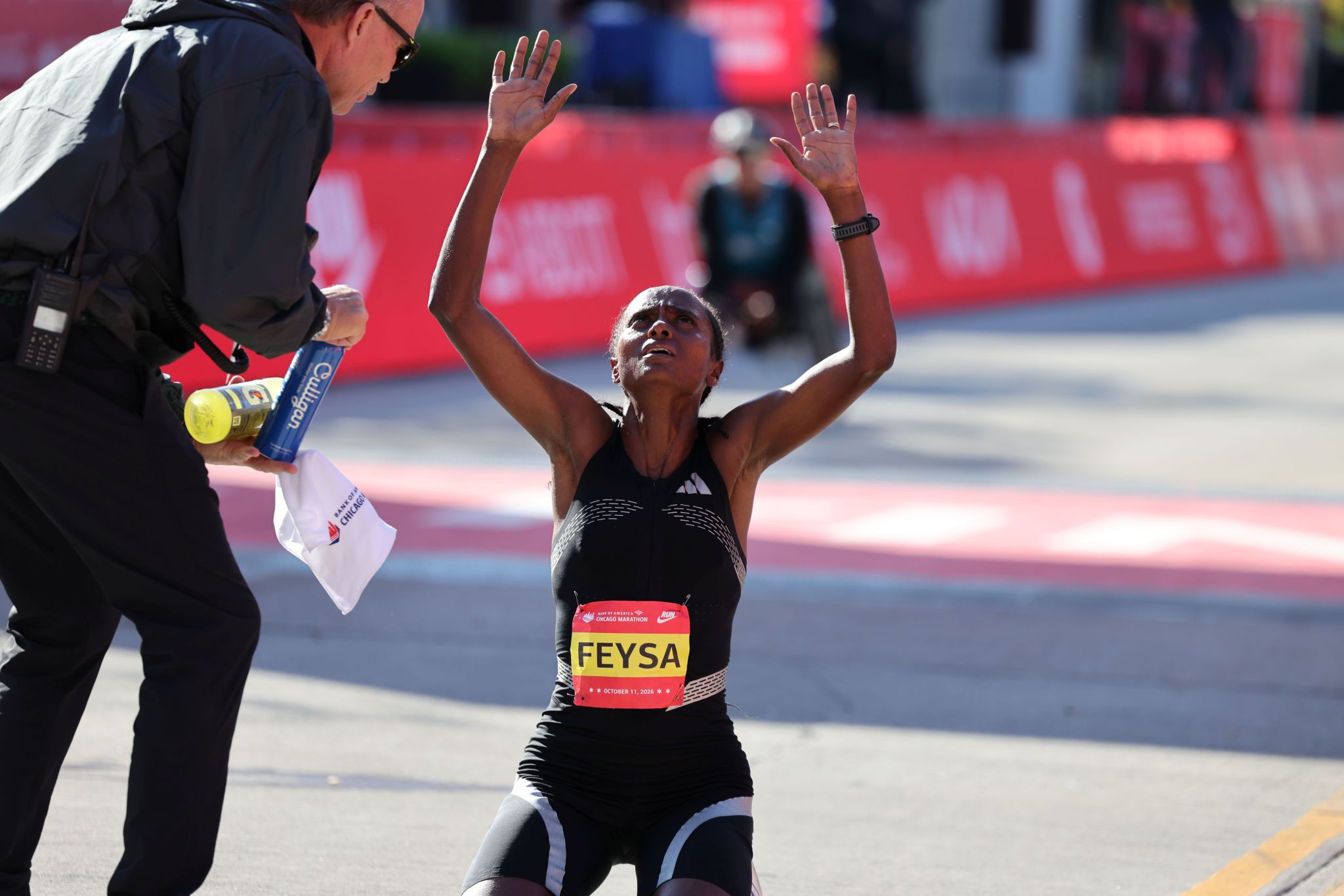Hawi Feysa raising her arms at the Chicago Marathon finish