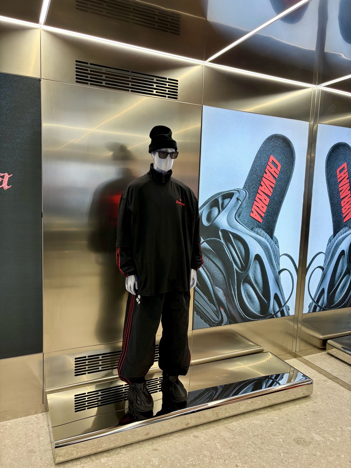Black-clad mannequin and campaign panel at the adidas Originals Via del Babuino store in Rome.