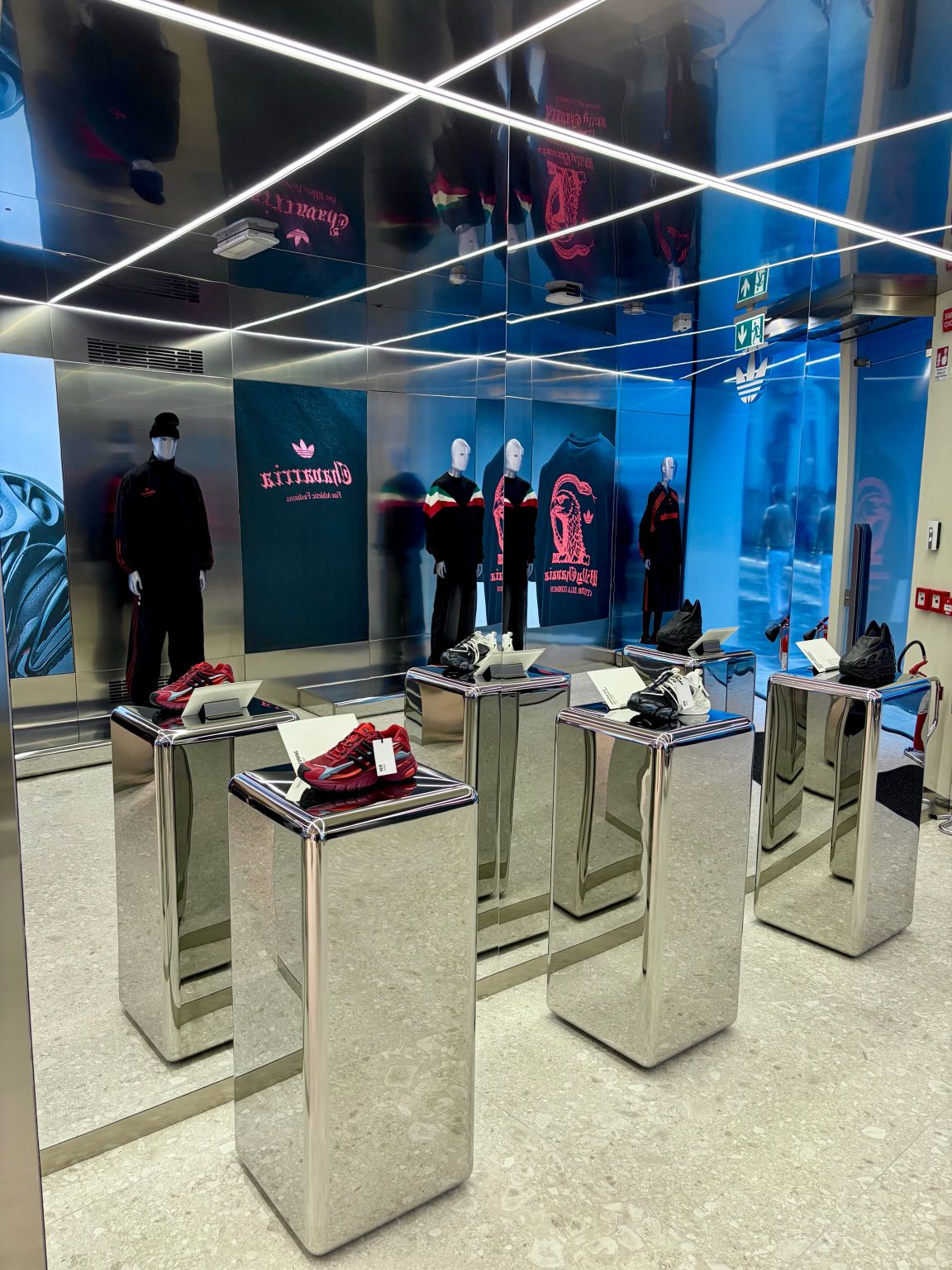 Footwear on mirrored display plinths at the adidas Originals Via del Babuino store in Rome.