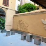 Courtyard at the adidas Originals Via del Babuino store with a raised street-map motif, metal seats and adidas Originals Roma branding.
