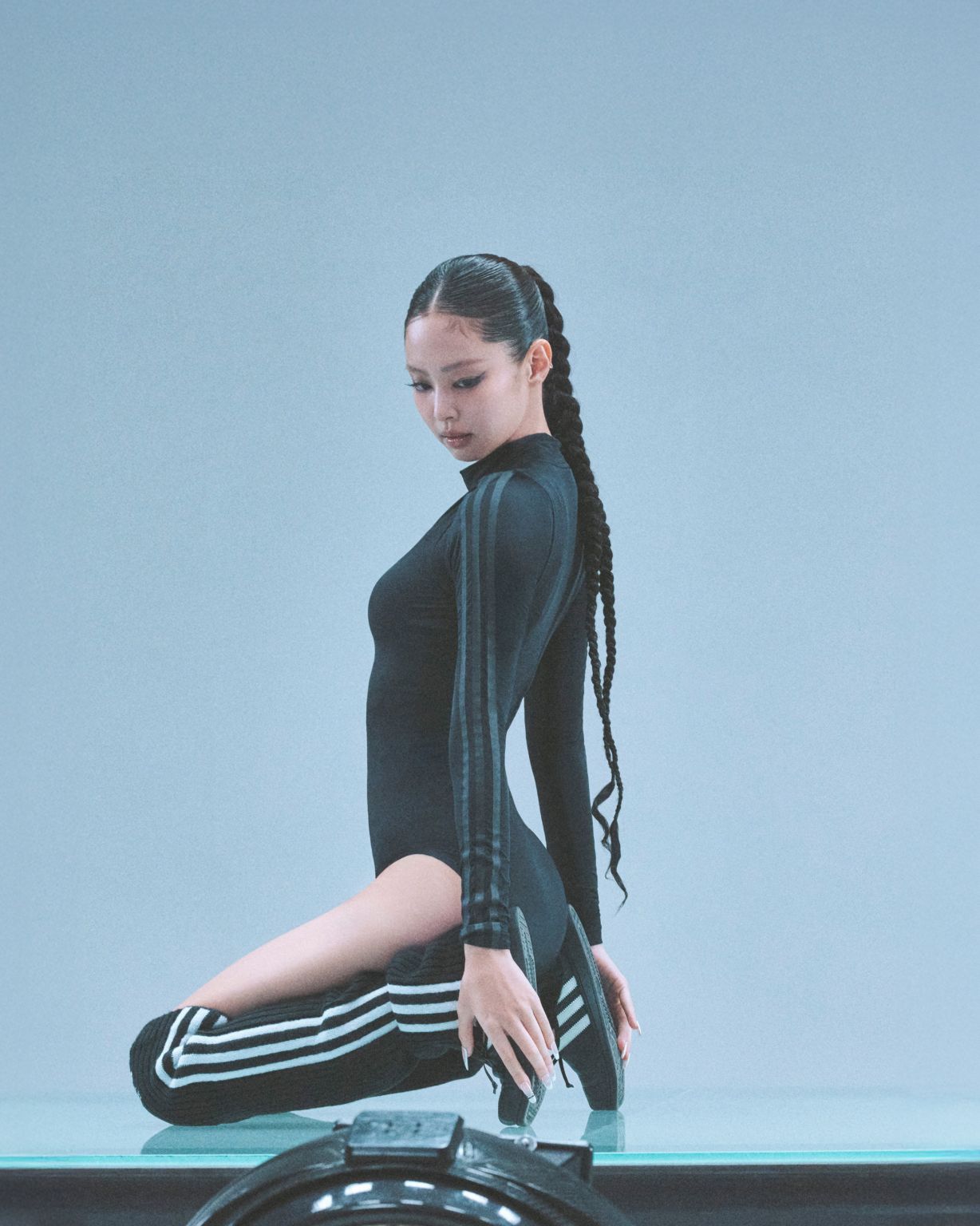 Model wearing adidas apparel and carrying a shoulder bag