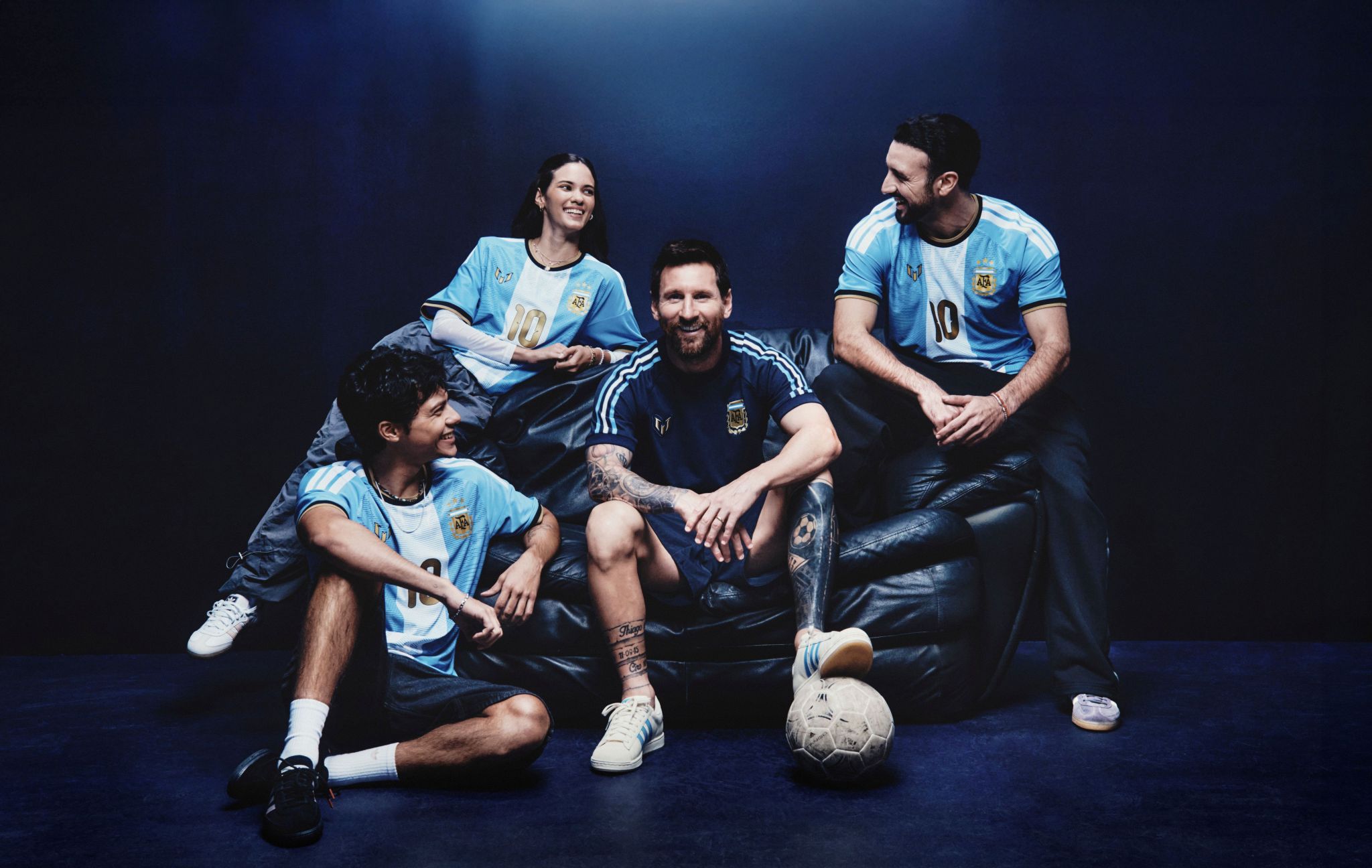 Four athletes in adidas sportswear with footballs
