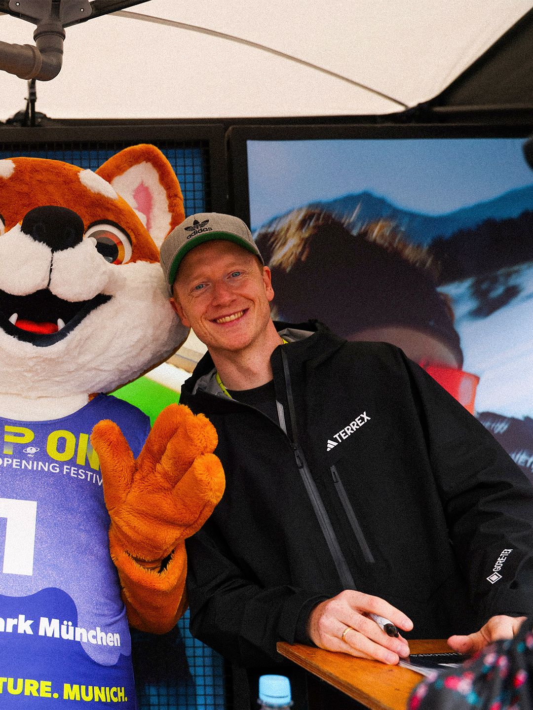 Athlete posing with the Loop One mascot