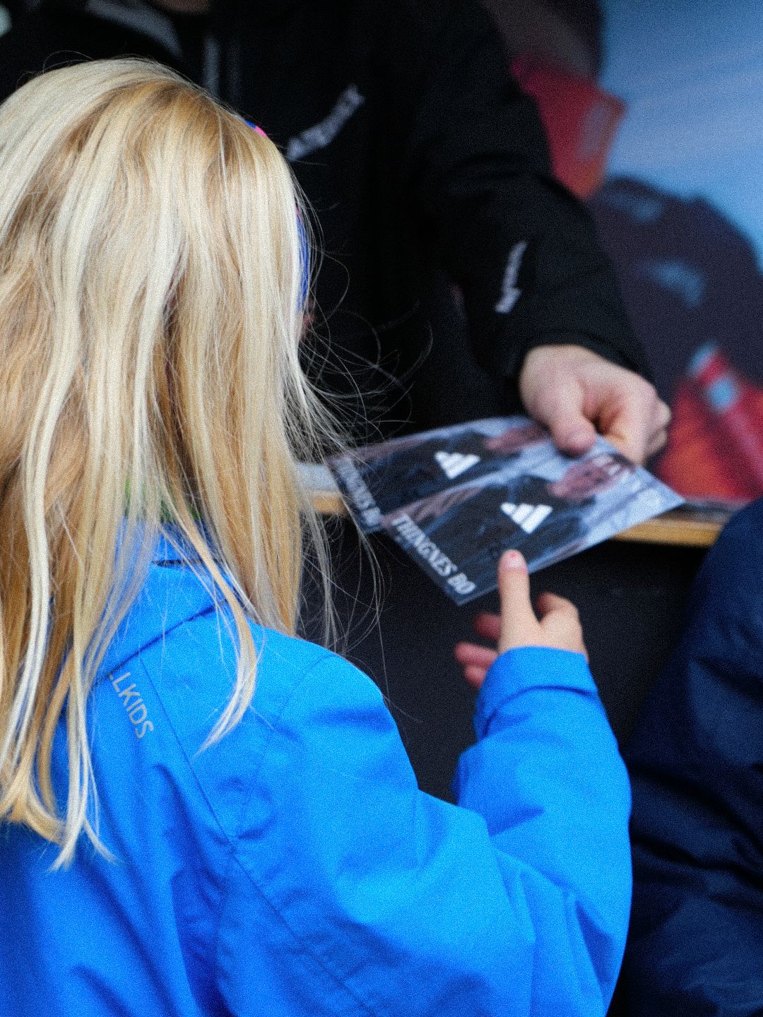 Fans having memorabilia signed at an adidas event
